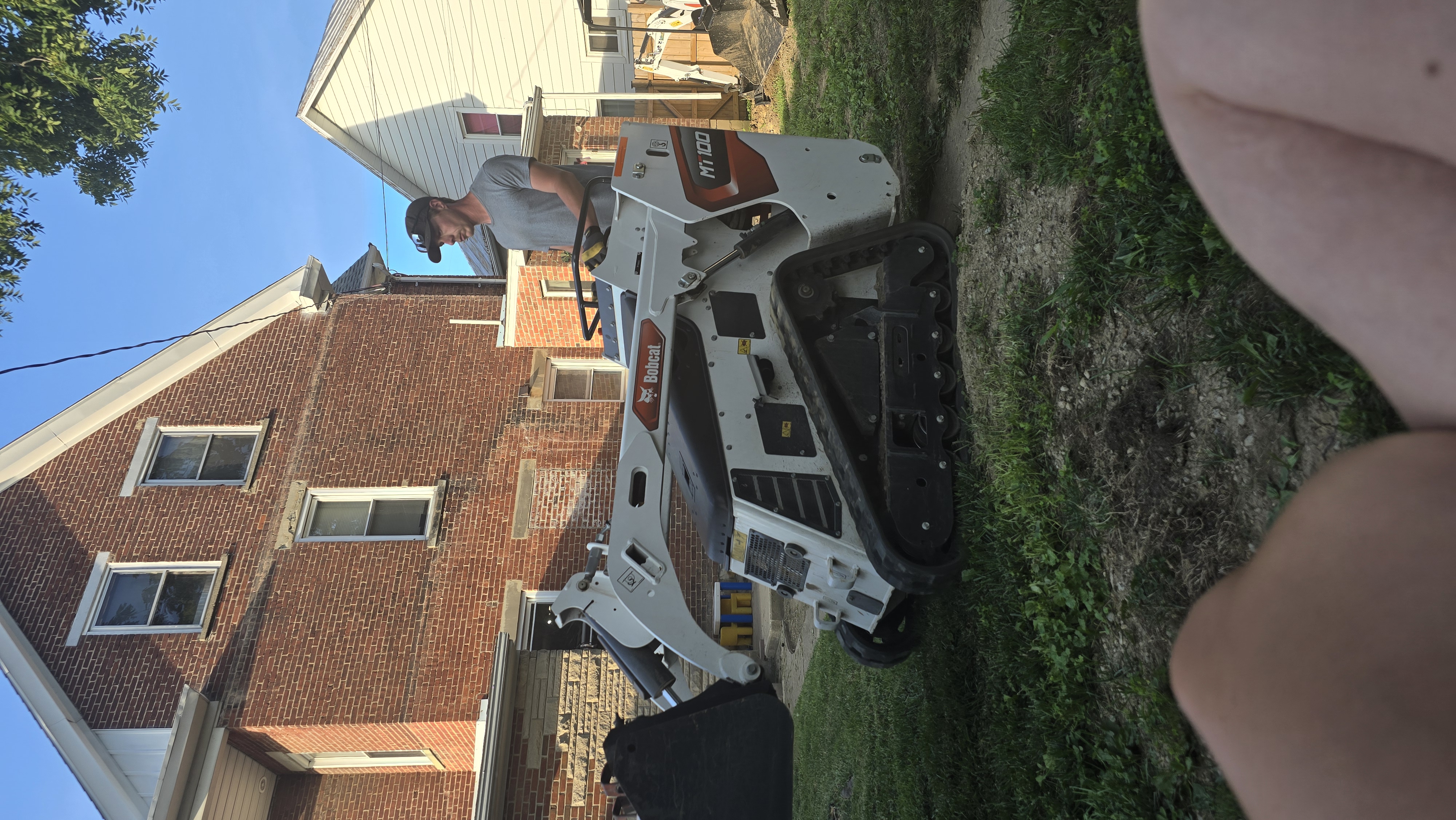 Mini Track Loader in Small Yard